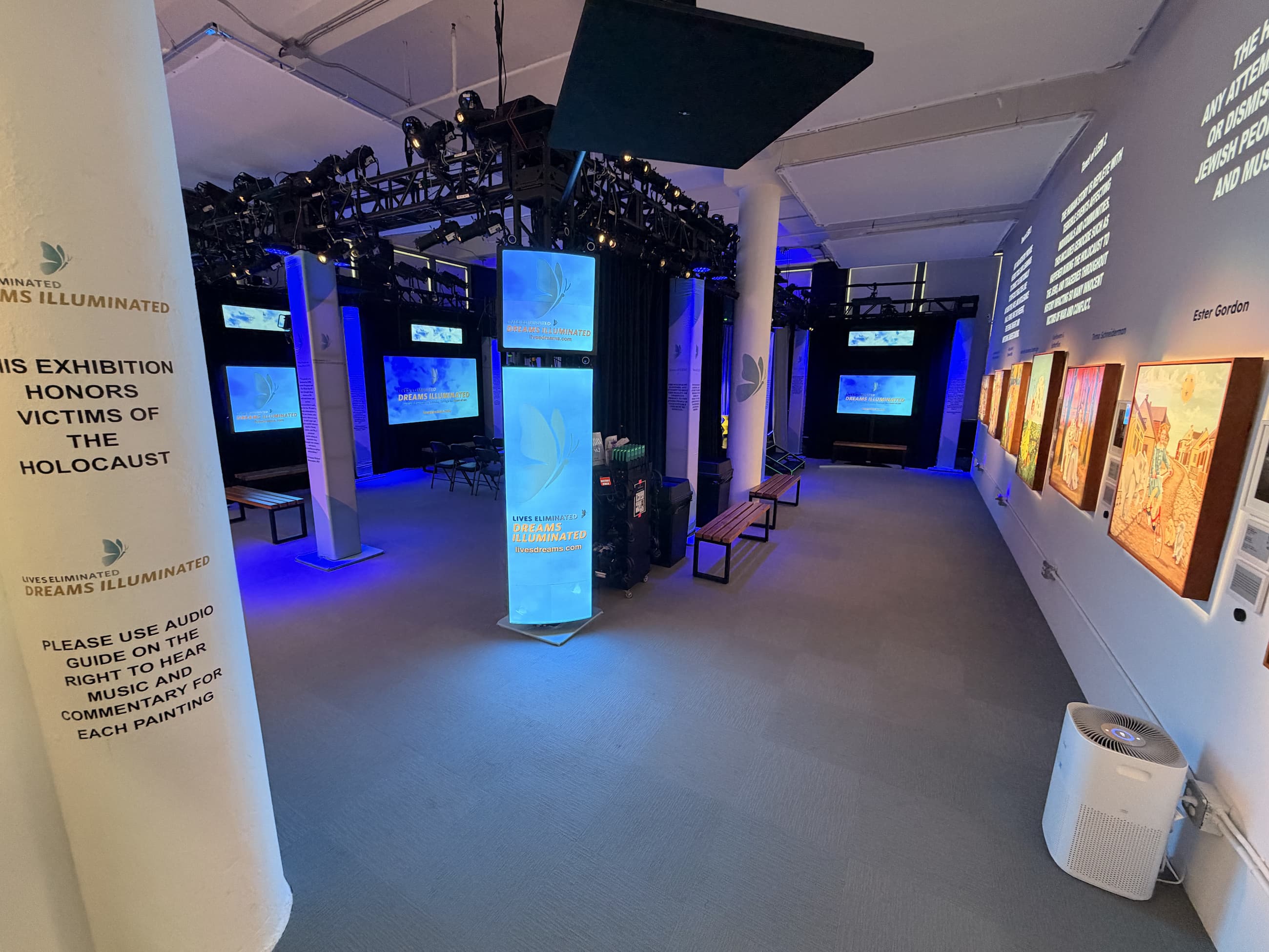 LEDI Center exhibition interior with paintings and blue lighting